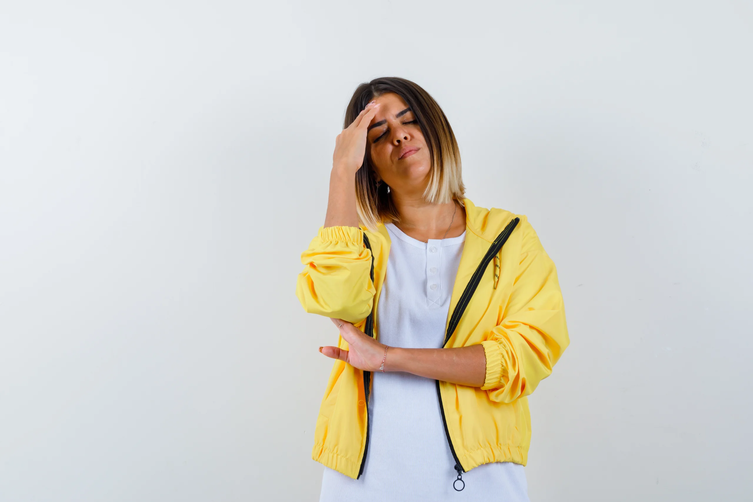 13 strategies to help cope with overwhelm and achieve a more balanced life 2 young girl white t shirt yellow jacket putting hand forehead having headache looking exhausted frontwebp scaled