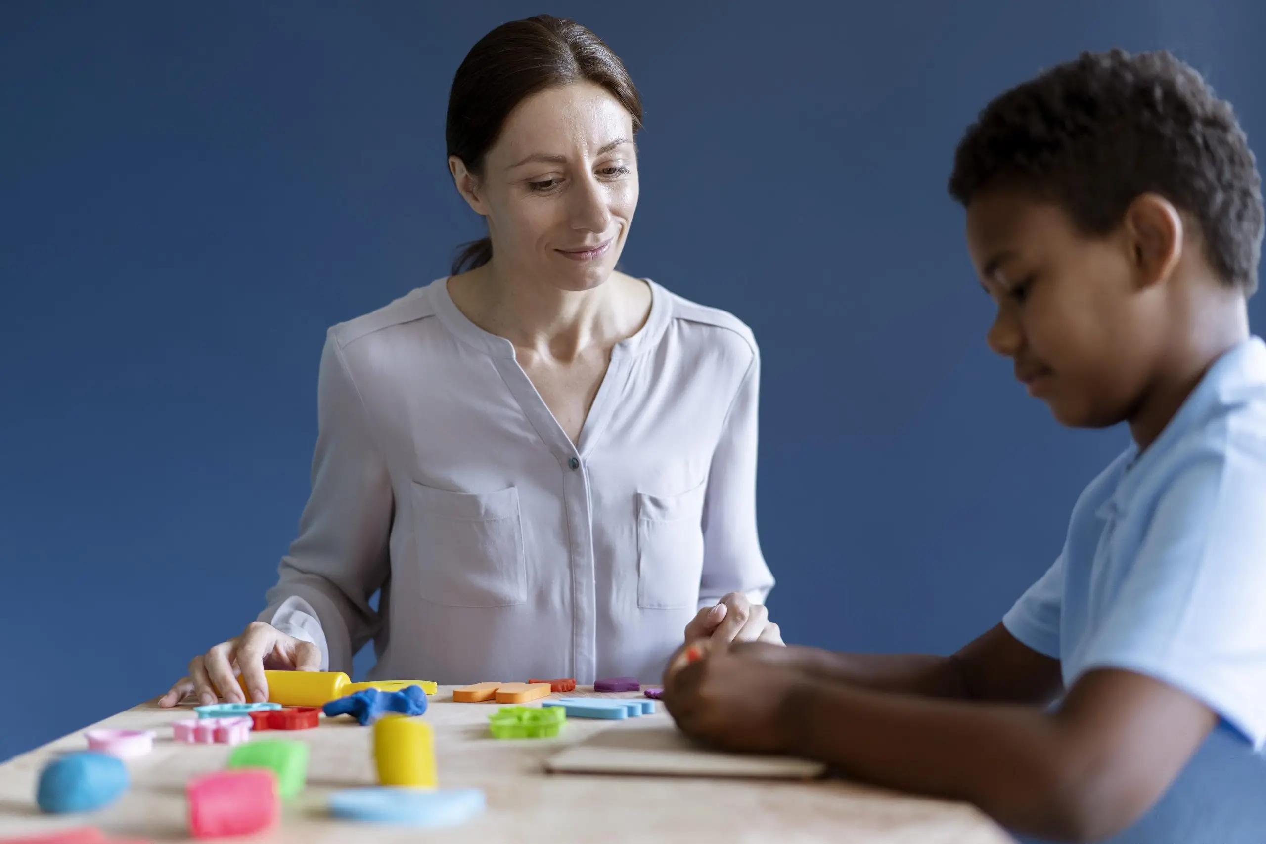 boy doing occupational therapy session with psychologist scaled