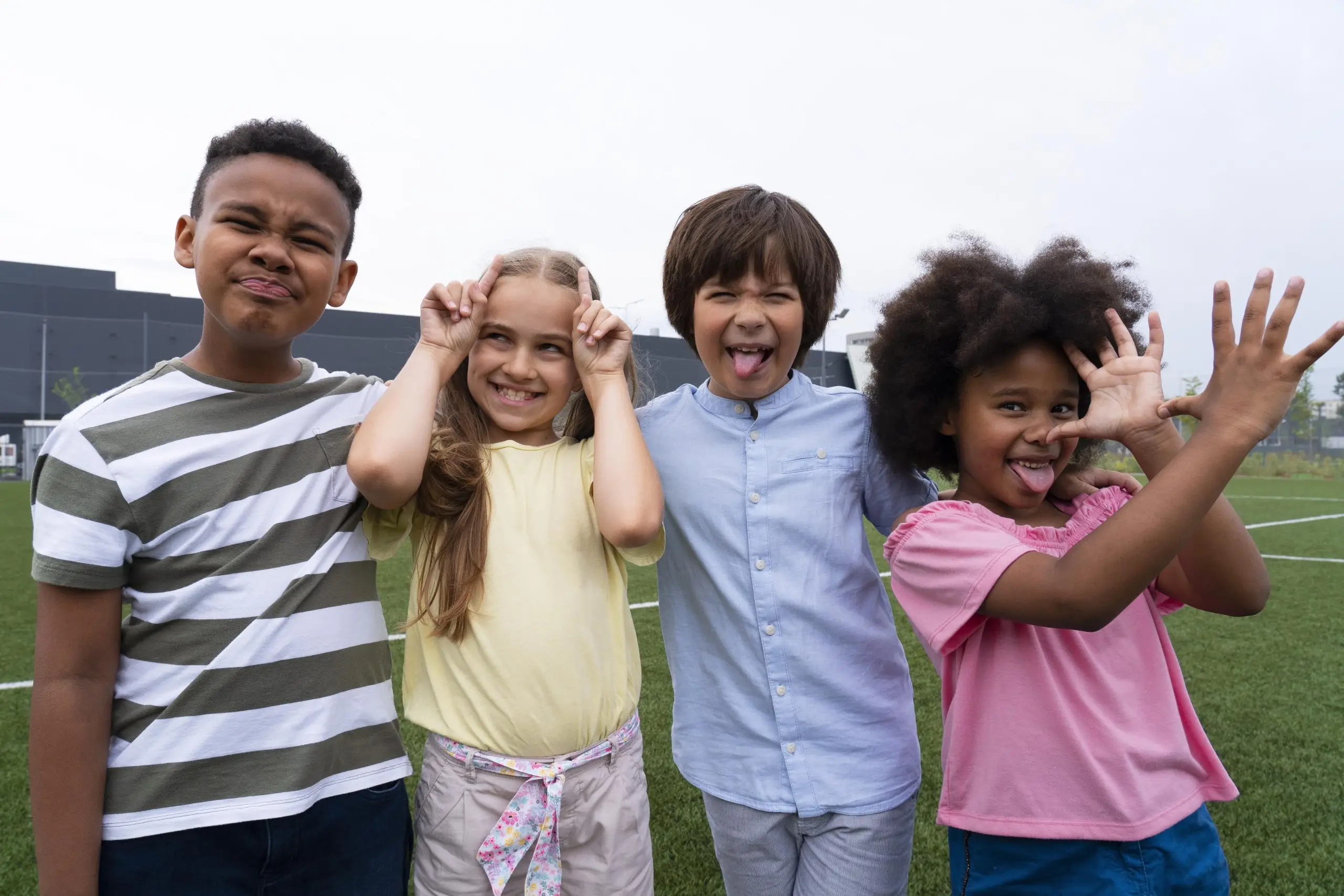 medium shot kids making funny faces scaled